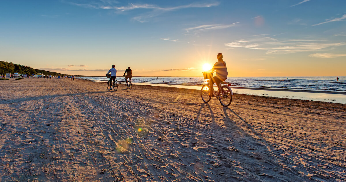 Tourists riding bicyle on Wasaga Beach